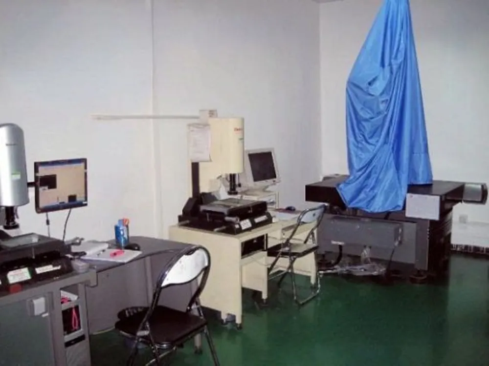 Measuring room with profile projector microscope and gauges used to check moulded parts against the drawing.