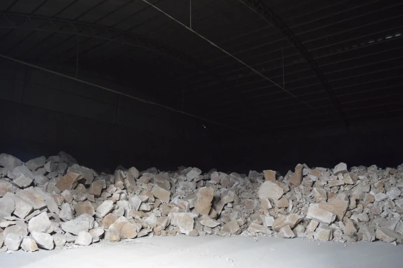 Raw nepheline syenite ore stored under cover