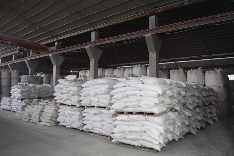 Stacked 50 kg woven bags on pallets in the warehouse
