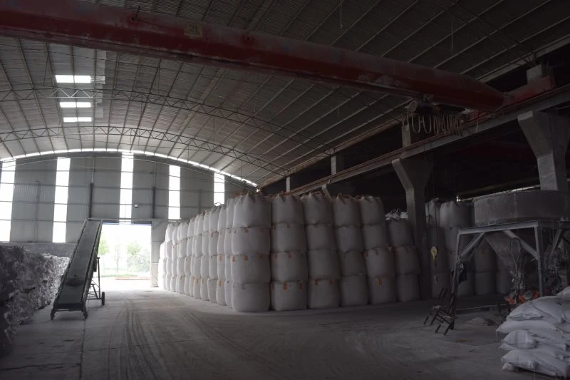 Jumbo bags stacked beside the warehouse doorway