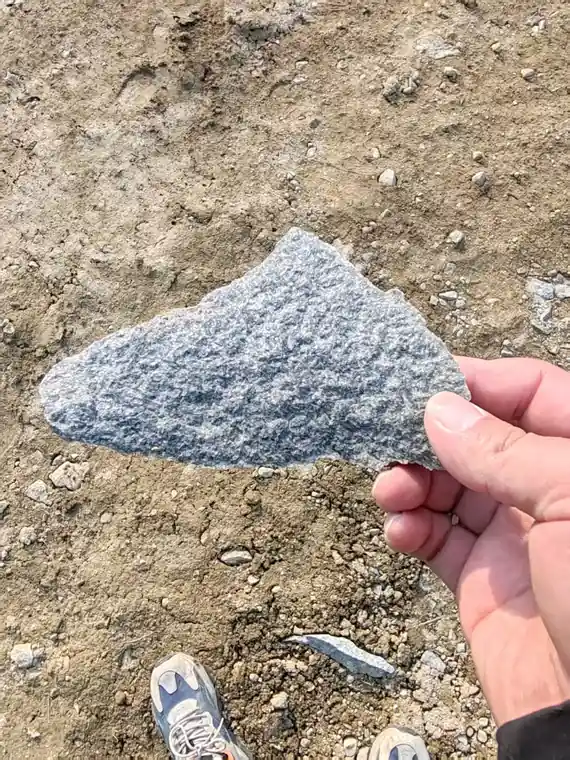 Hand-held sample of nepheline syenite fines