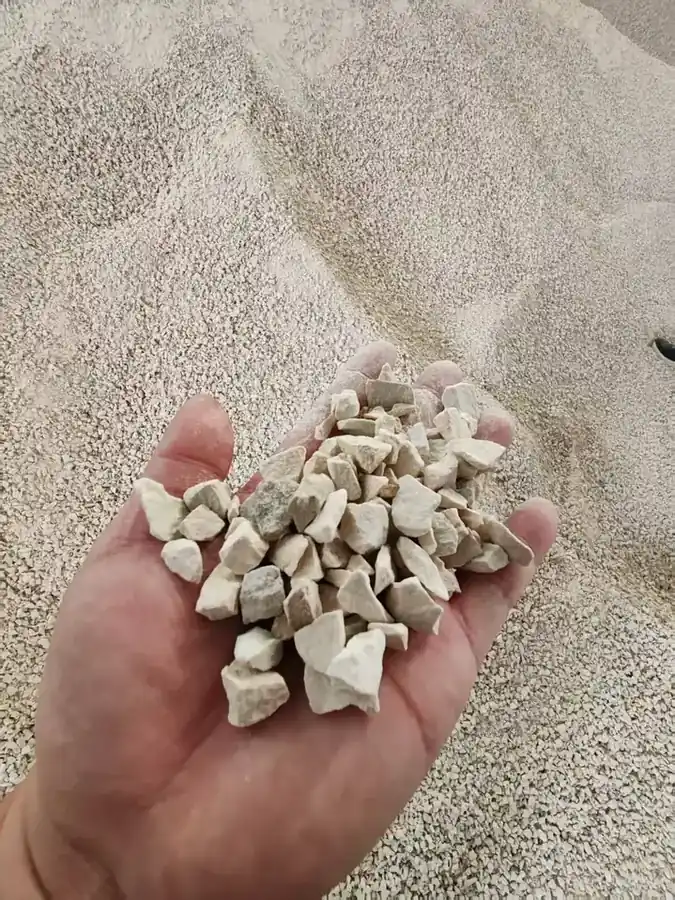 Crushed potassium feldspar held in the hand