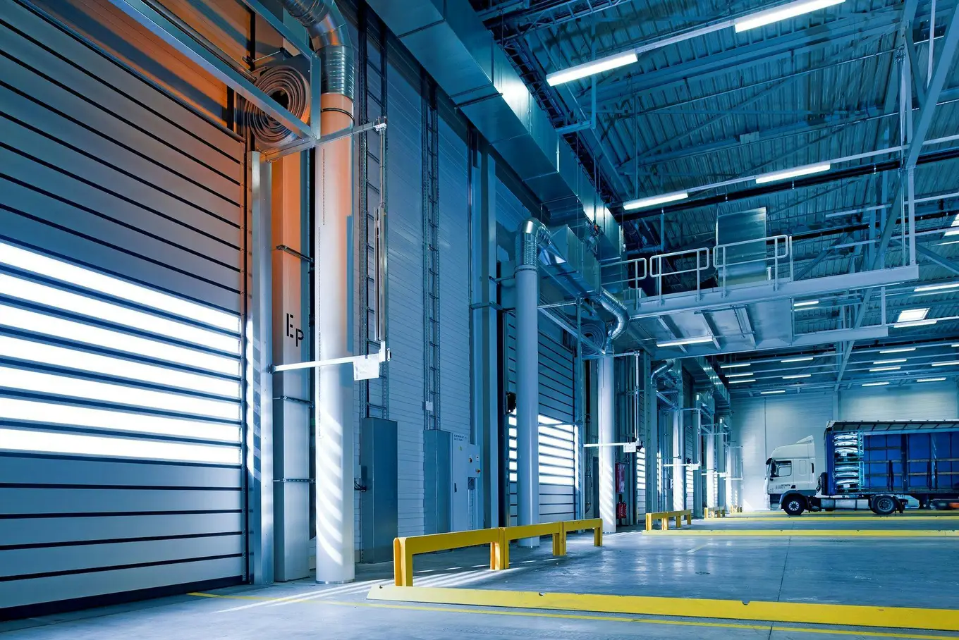 Loading bays and dispatch hall of a modern industrial warehouse with a container truck
