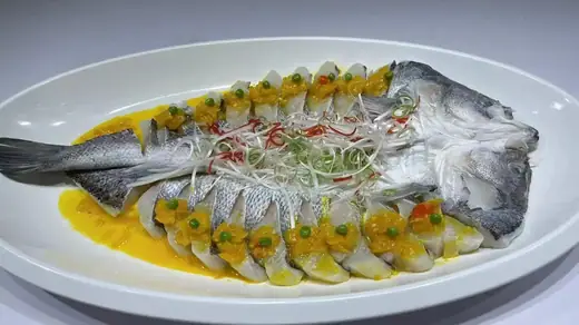 Steamed whole seabass plated for restaurant service