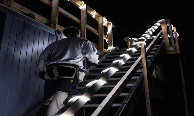 Stair core lit with a single continuous mains-voltage run.