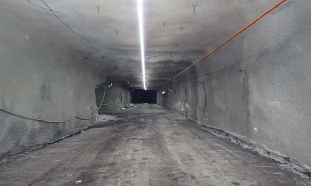 Tunnel run passing electrical cabinets underground.