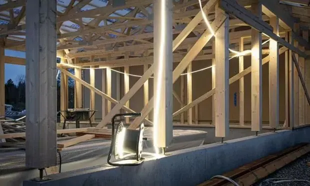 Timber frame construction lit during fit-out.