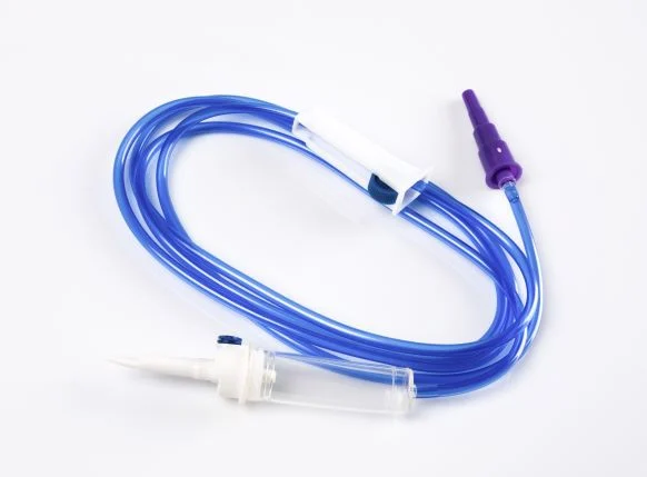 Medical IV infusion set with blue tubing, drip chamber, and roller clamp on white background