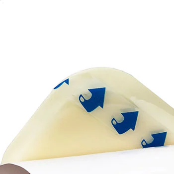 Close-up of translucent adhesive film with blue arrow peel indicators