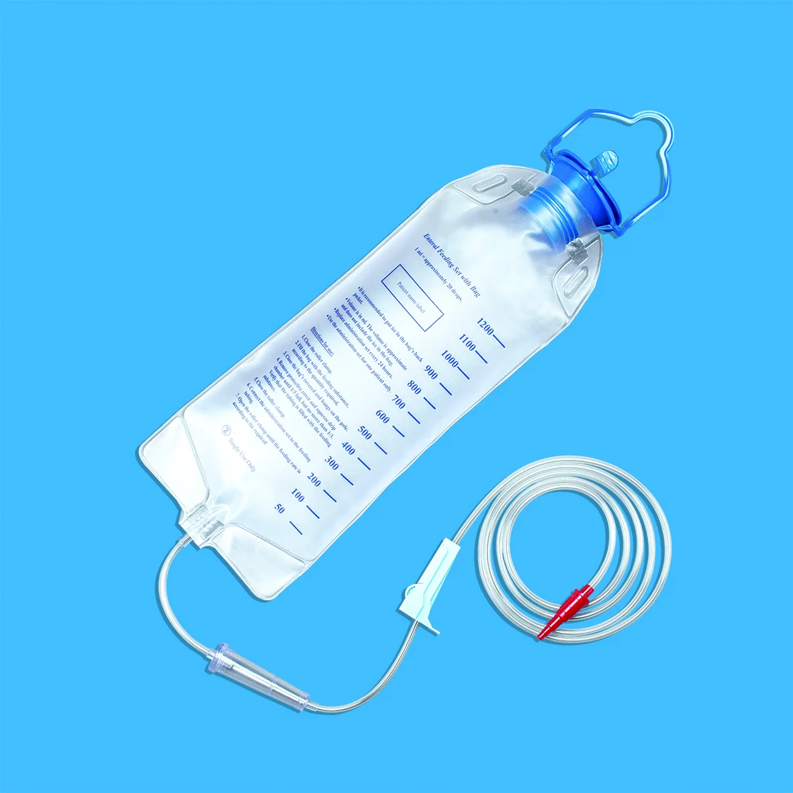 Clear enteral feeding bag with tubing and roller clamp on blue background
