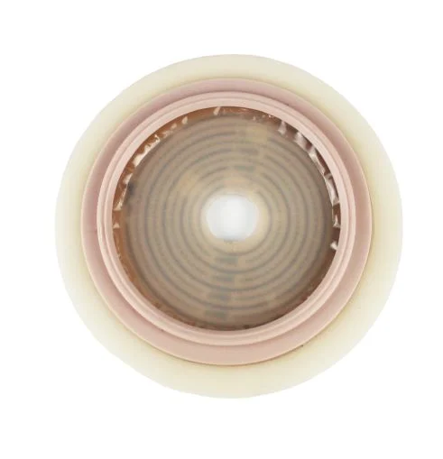 Circular adhesive ostomy barrier wafer on a white background