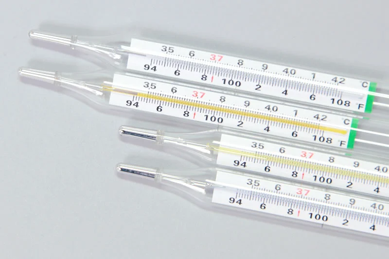 Four glass medical thermometers with dual Celsius and Fahrenheit scales