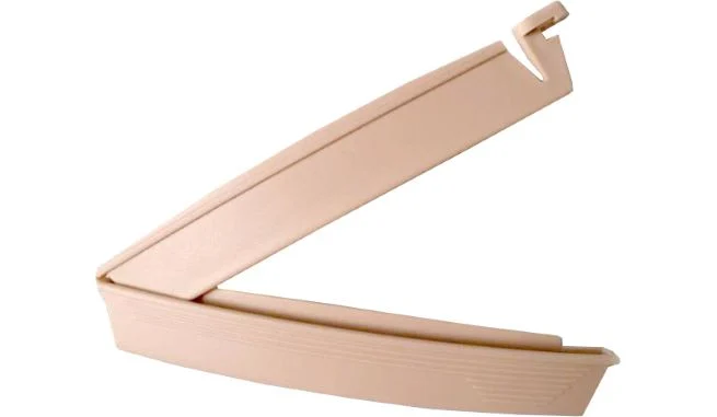 Beige plastic sealing clip open against a white background