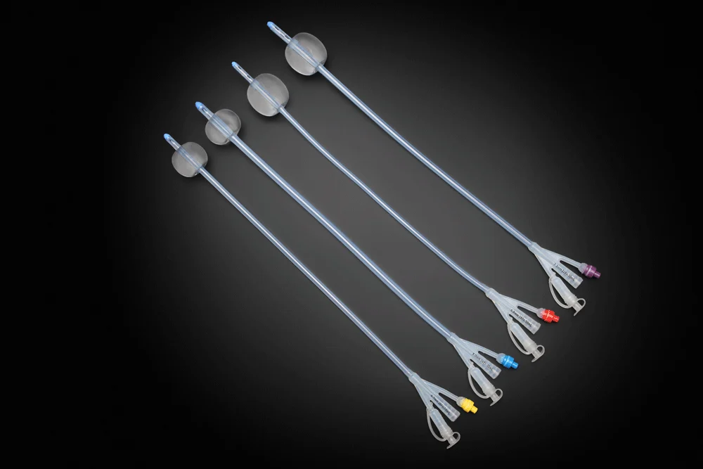 Four Foley balloon catheters arranged diagonally on a black background