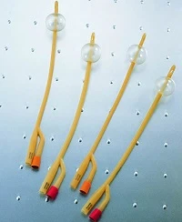 Four inflated Foley catheters shown on a metallic surface