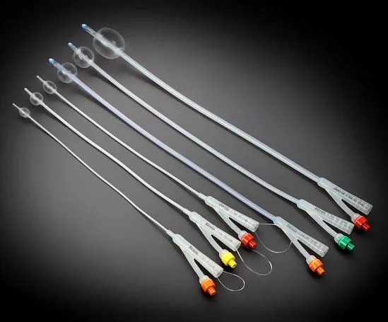 Assorted medical balloon catheters in various sizes displayed diagonally on a dark background.