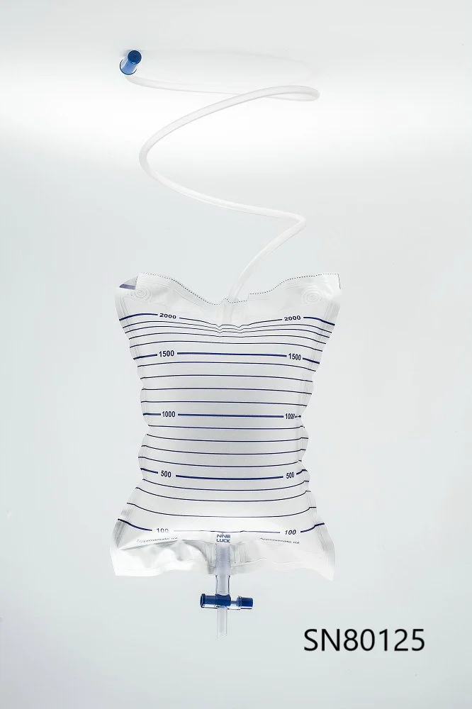 Medical drainage collection bag with measurement scale and tubing against a plain background