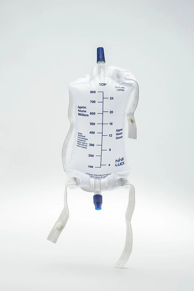 Graduated medical urinary leg bag with drainage port and straps on a white background