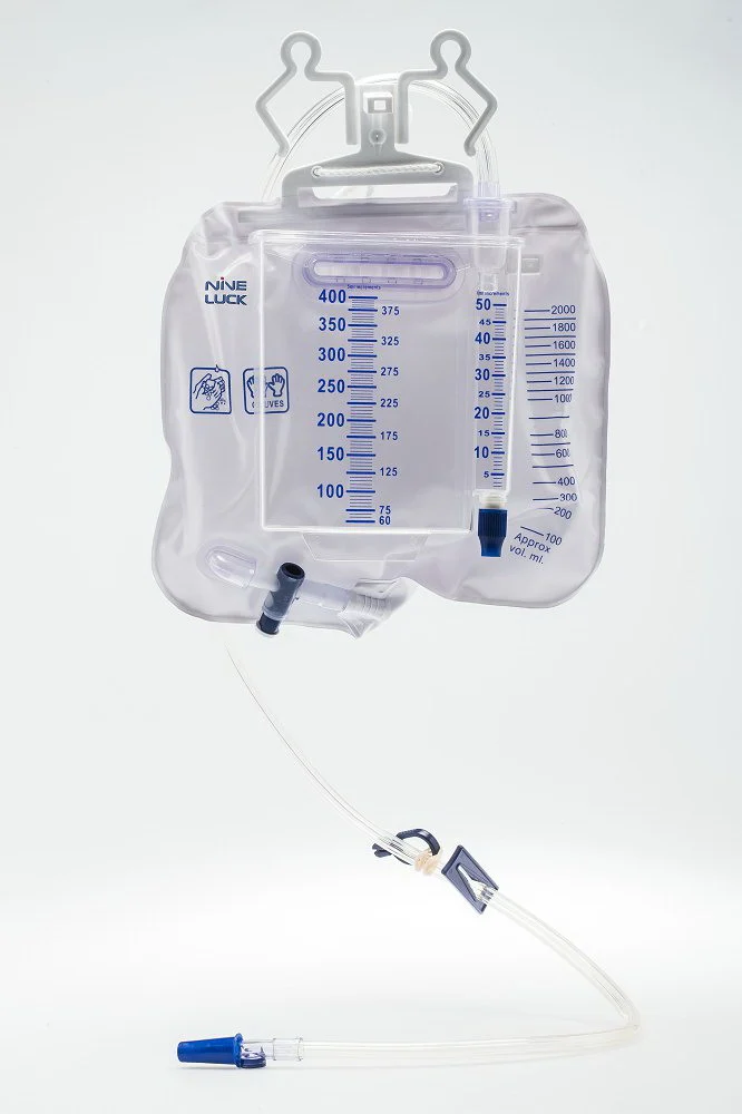 Medical urine meter drainage bag with graduated chamber and tubing against a white backdrop