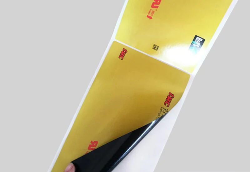Roll of black adhesive paper stickers ready for application