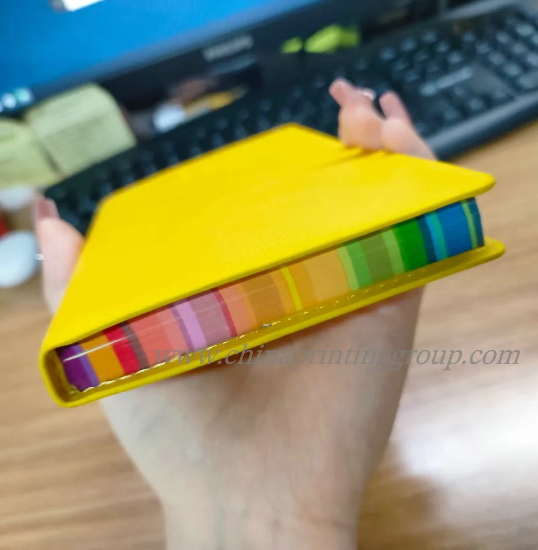 Stack of branded notebooks with different coloured edges