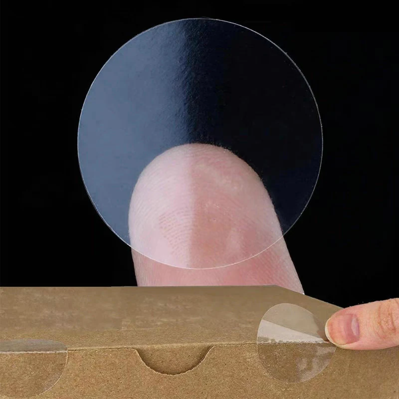 Clear custom sticker used as a packaging seal on a box