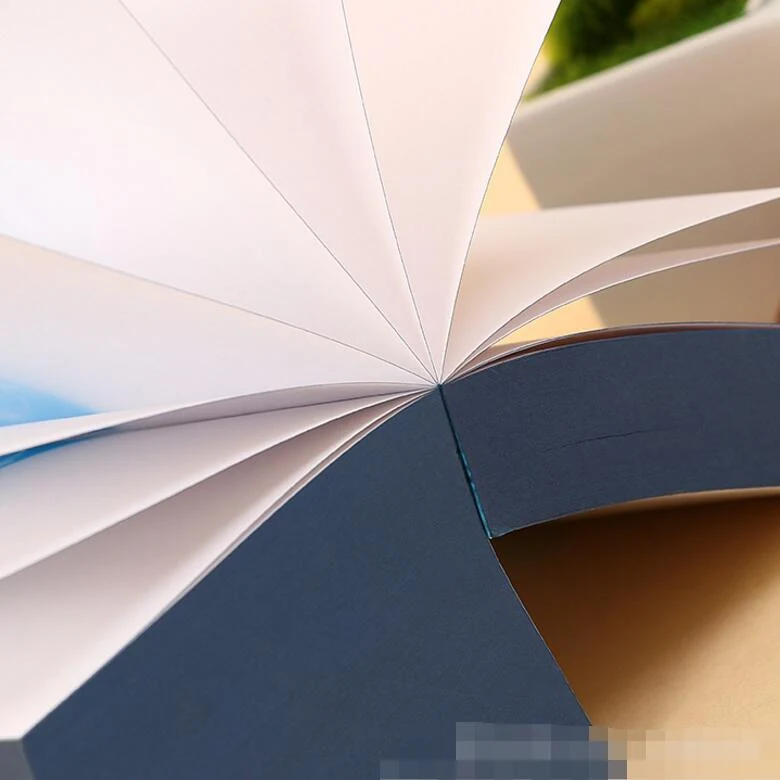 Paper cube notepad showing glued edge binding and stacked sheets