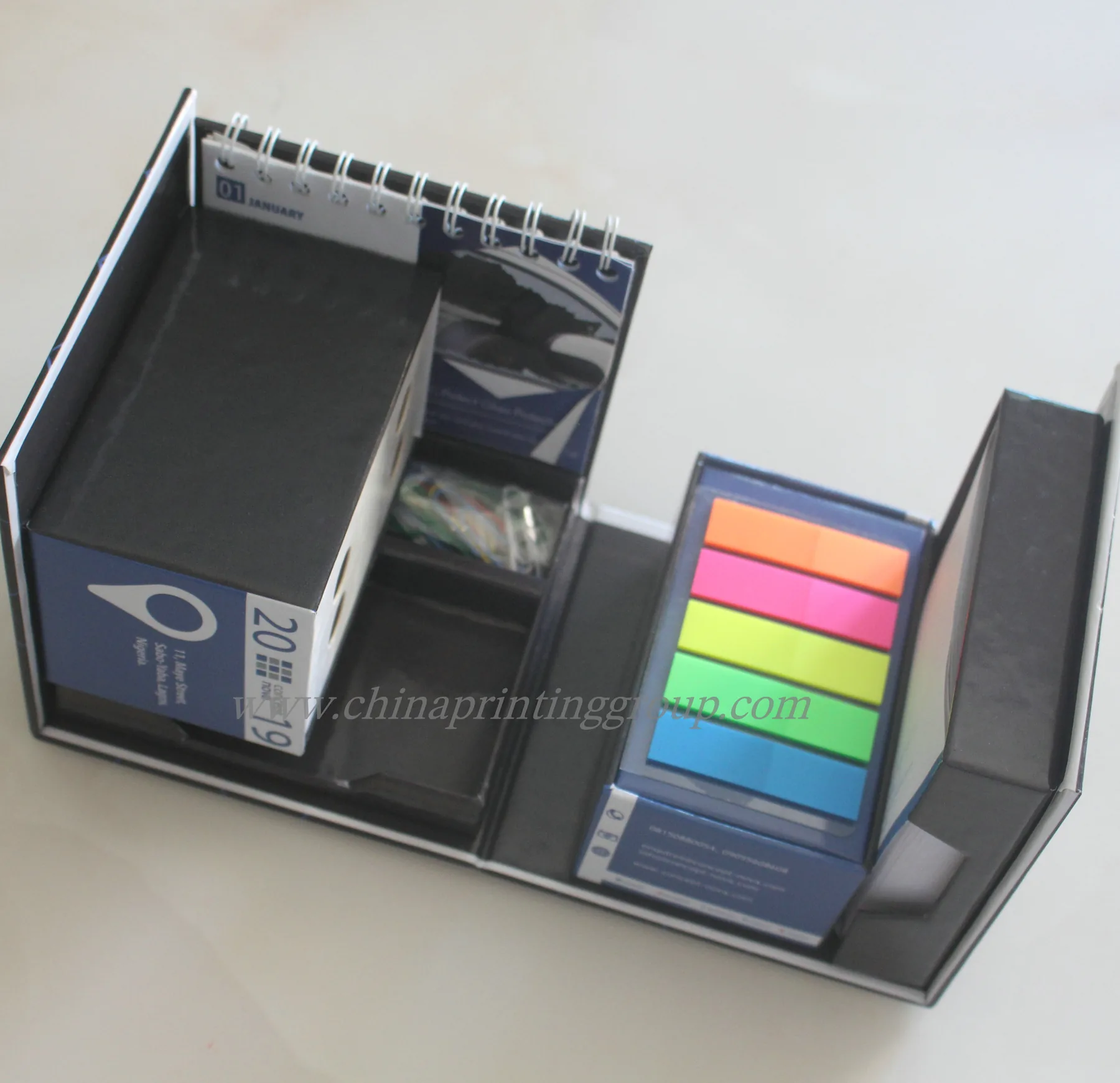 Cardboard notepad box open to show memo pad and pen slot