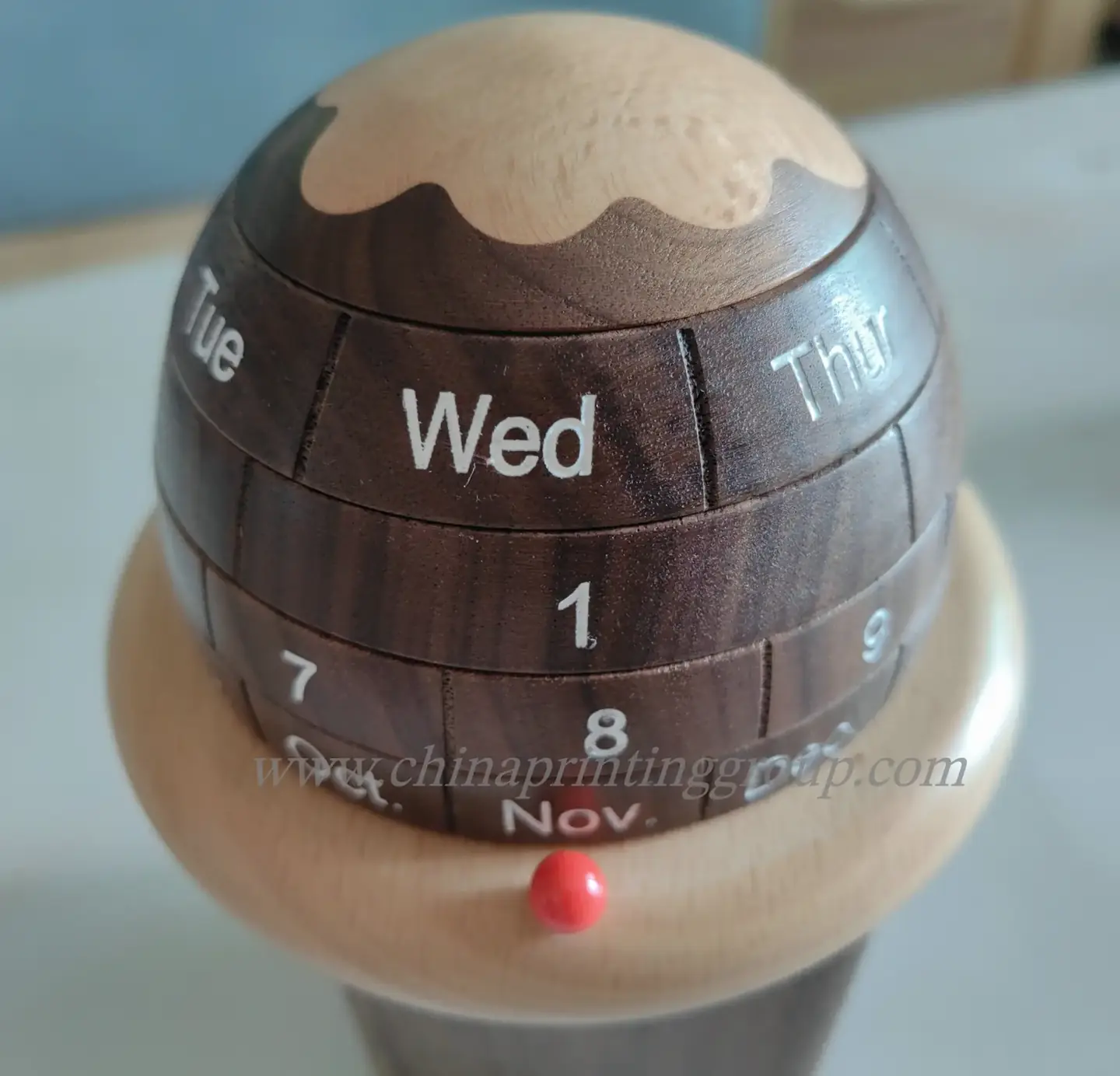 Hand-painted wooden block calendar on an office desk