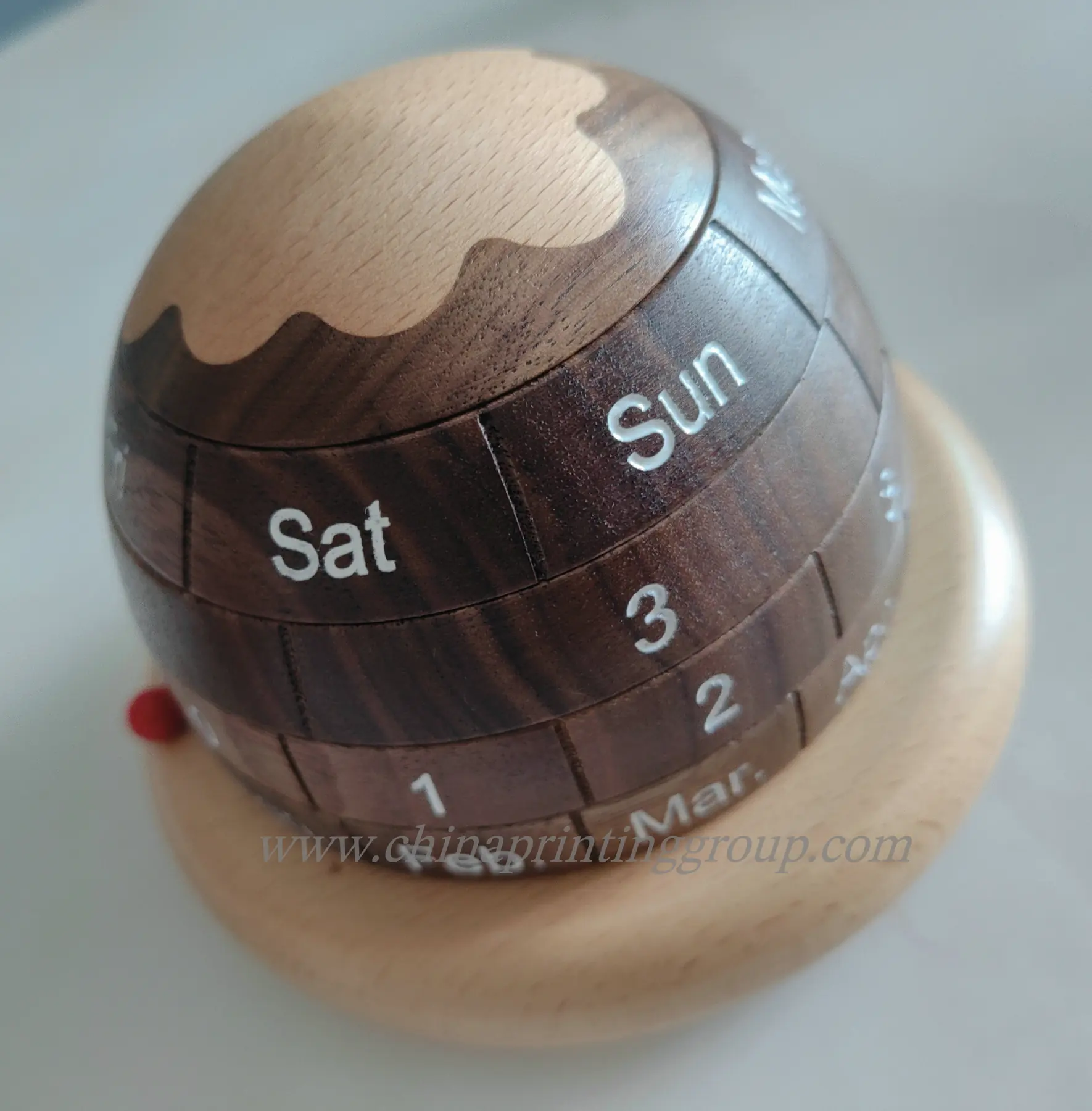 Custom logo engraved on the base of a wooden desk calendar