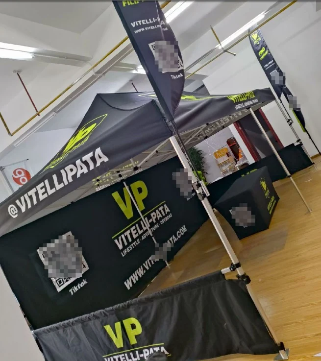 Custom printed pop up canopy tent with branded back wall at an outdoor expo