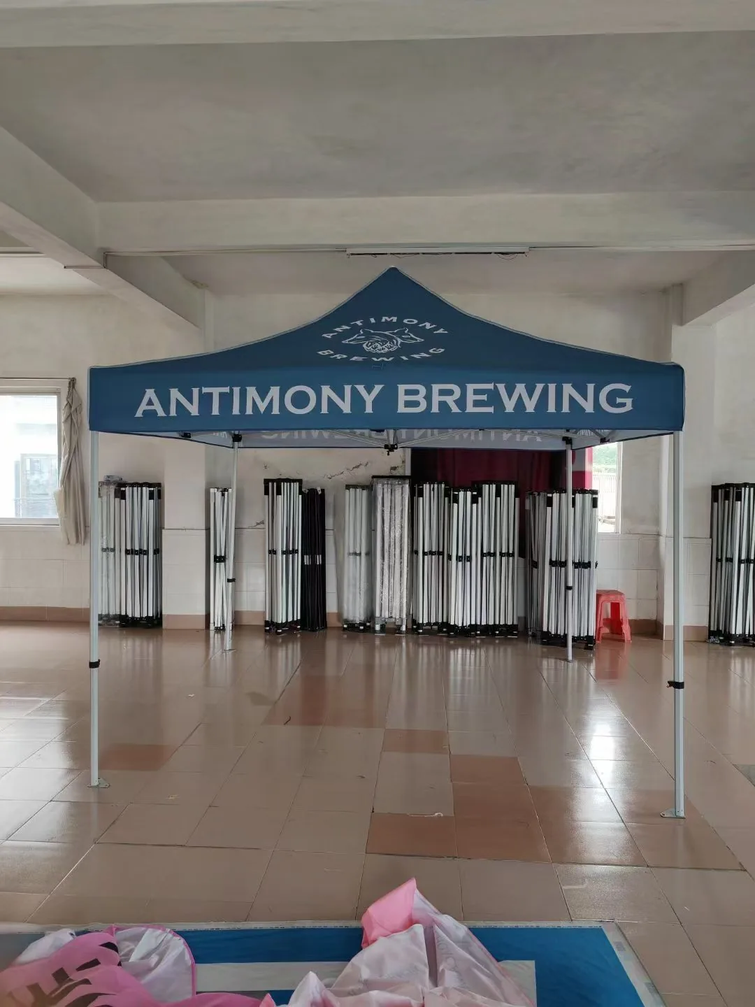 Canopy tent with half back wall used as a street marketing stand