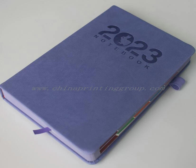Gold foil logo ironed into an imitation leather journal cover