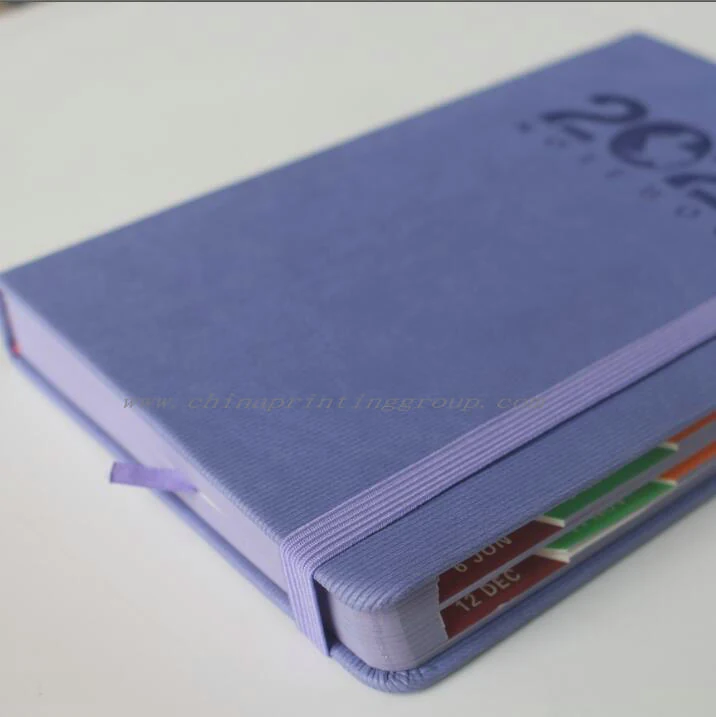 Leather journal opened to show the printed planner inner pages