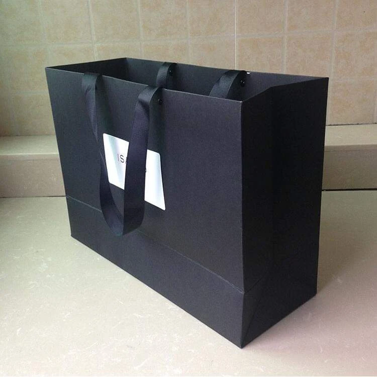 Group of black custom paper bags in several sizes