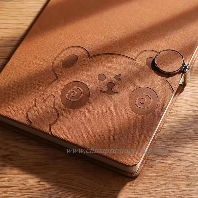 Close view of a debossed logo pressed into a PU notebook cover
