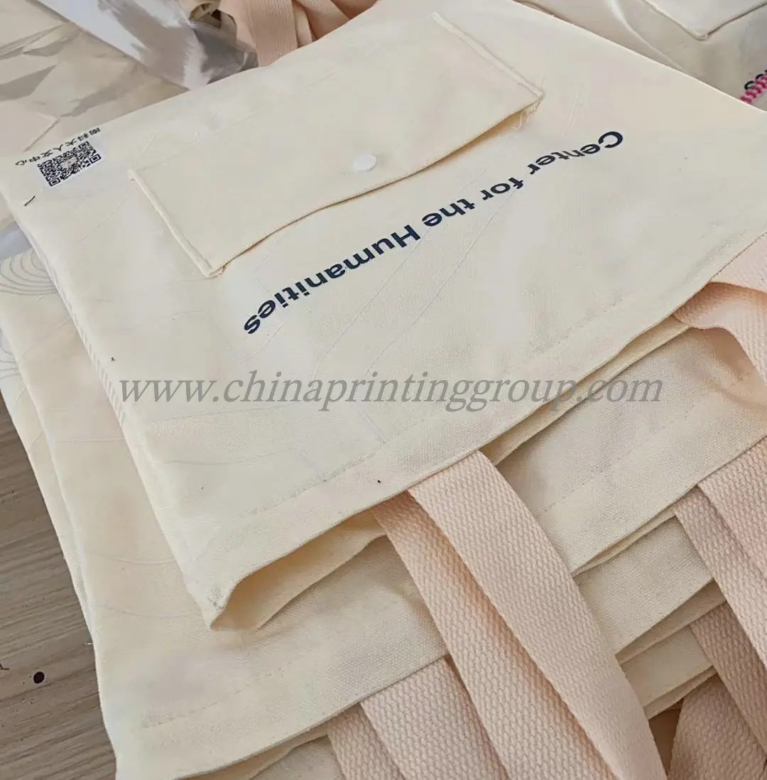 Cotton tote bag held open showing the interior and seams
