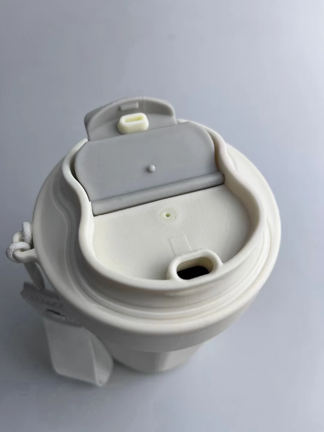 Custom branded vacuum travel mug photographed in use