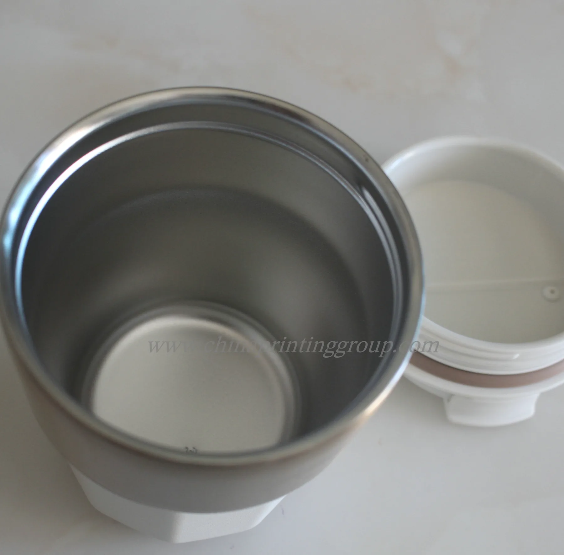 Insulated travel mugs shown in several colours