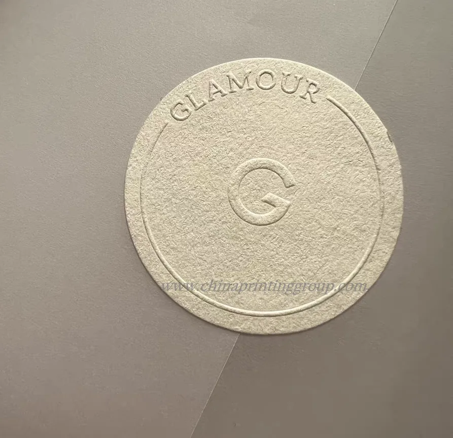 Debossed logo sticker applied to a gift box closure