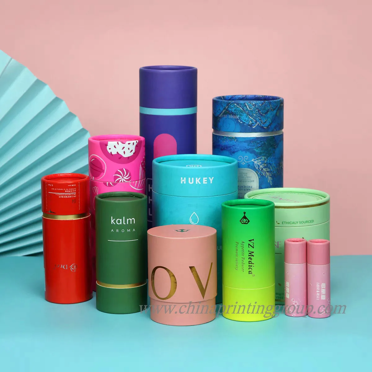 Biodegradable cardboard cylinder container shown open with lid beside it