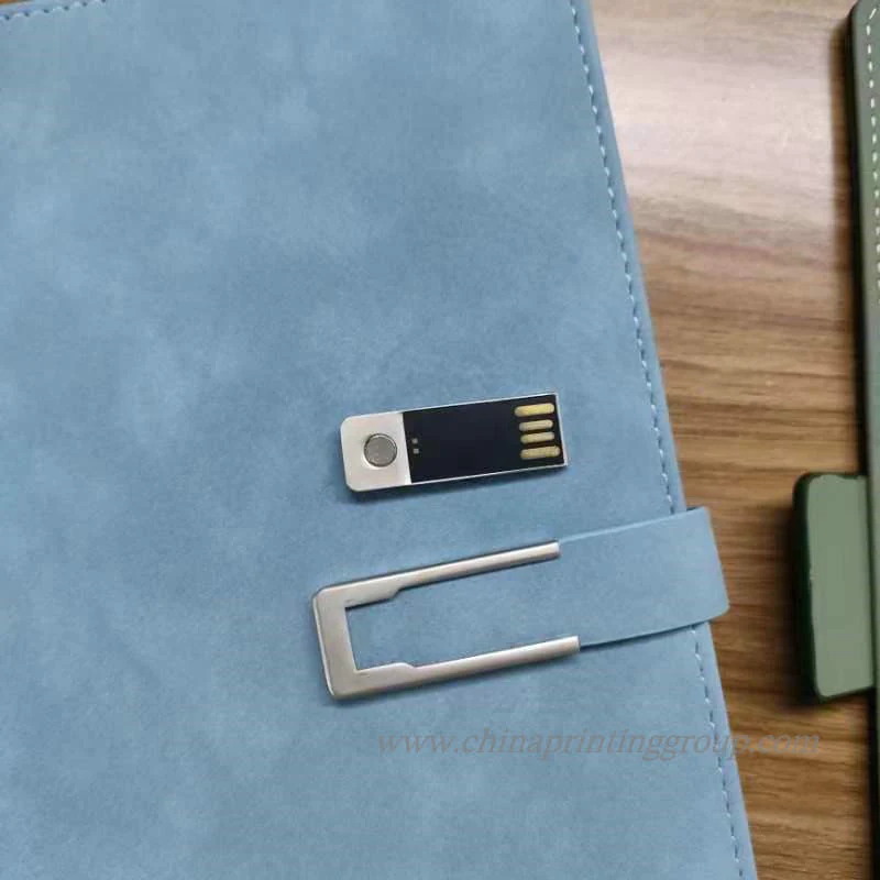 Notebook cover with embedded metal logo plate