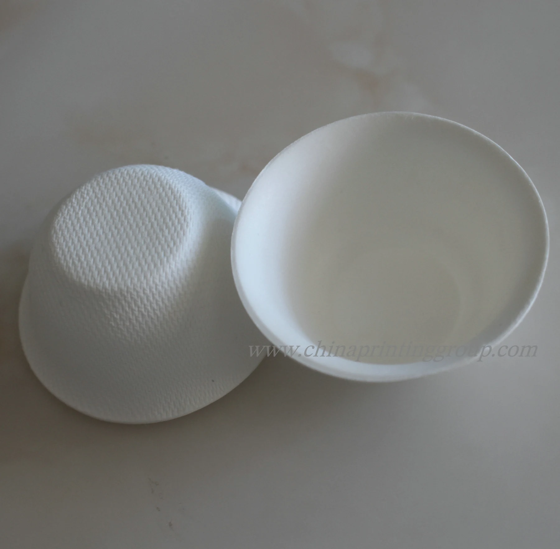 Sugarcane bagasse packaging box shown open with a fitted insert