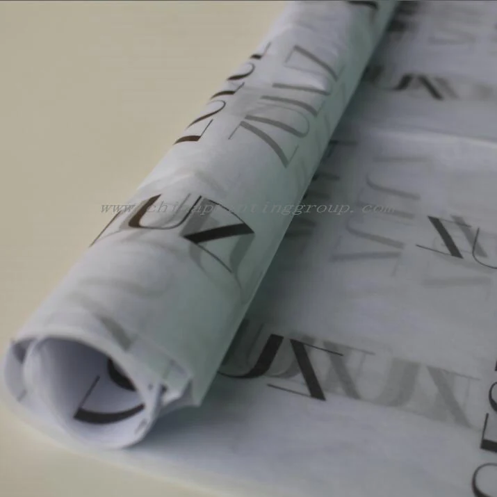 Printed tissue paper sheets folded around garments in a box