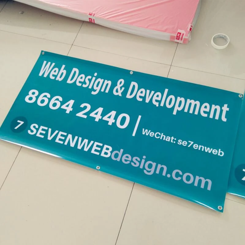 Custom printed mesh fabric banner fixed to an outdoor fence