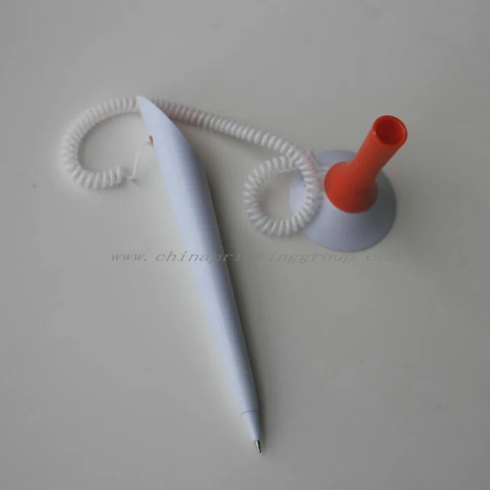 Desk pen and holder with the plastic chain tether visible