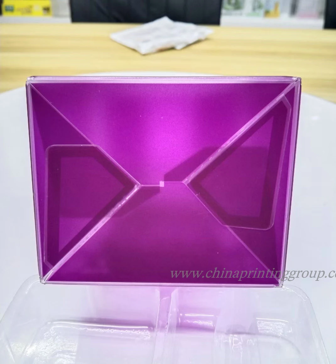 Clear plastic food packaging box filled with macarons