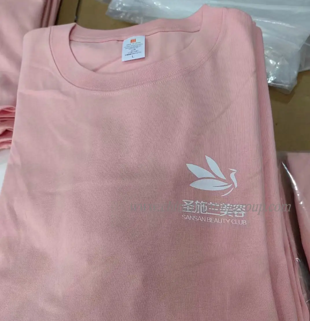 Stack of promotional custom printed t-shirts in assorted colours