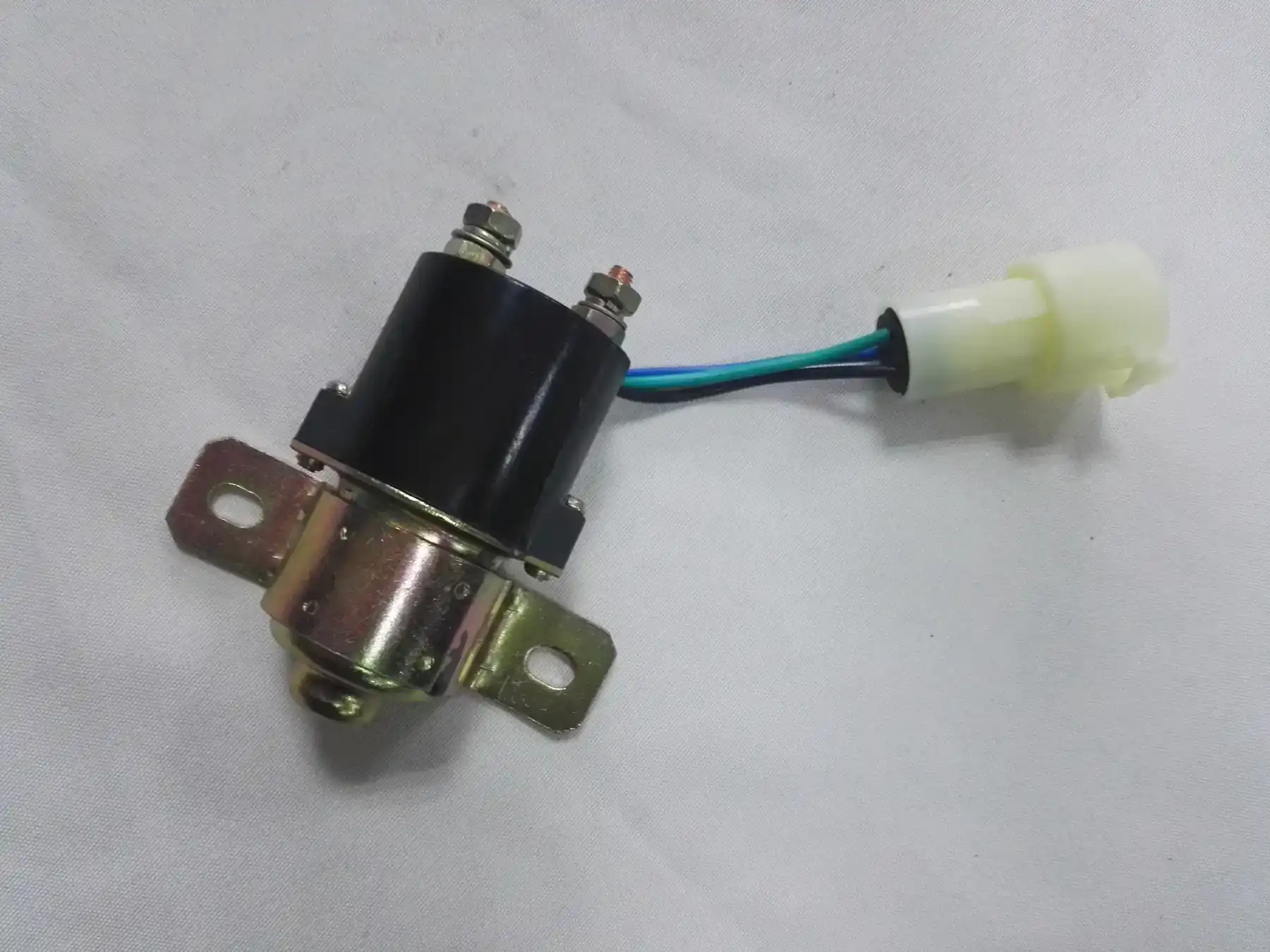 Battery switch relay with its mounting bracket and harness connector fitted