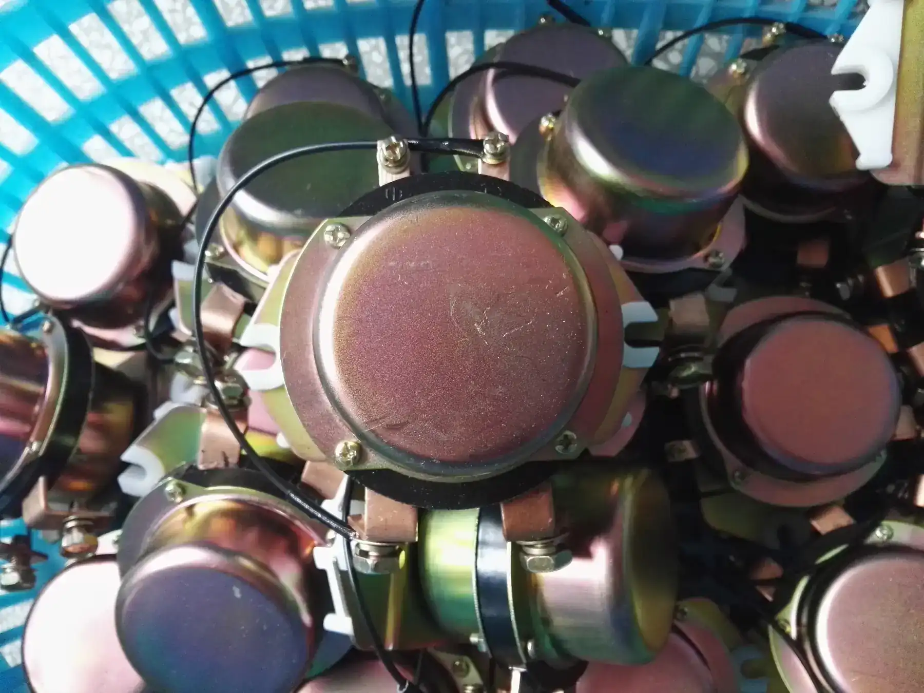 Zinc plated relay bodies staged in the assembly area before final function test